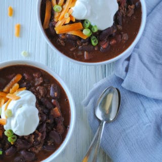 two bowls of chili and spoons