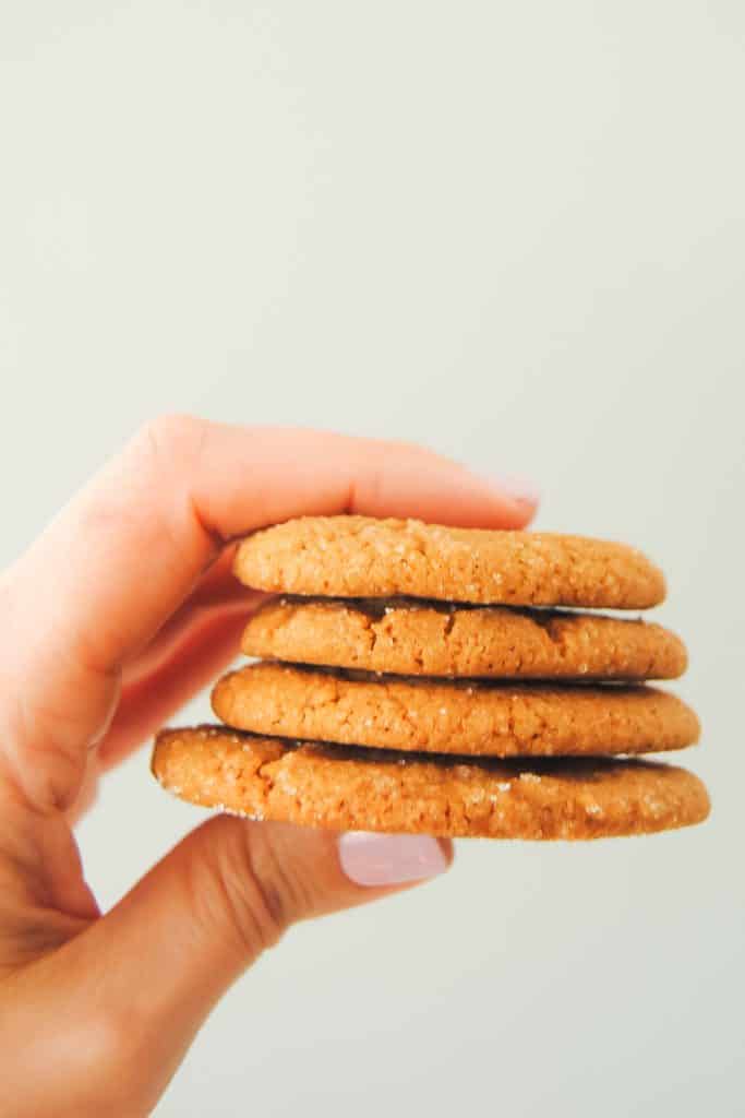 hand holding a stack of ginger cookies