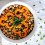 chickpea salad with orange peppers and parsley on white background