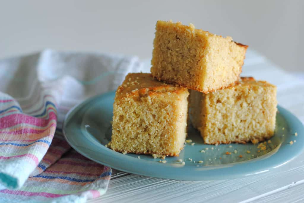 three slices of cornbread on teal plate