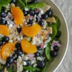 spinach salad greens with blueberries, mandarin oranges, goat cheese and red onion