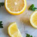 sliced lemons and parsley on marble background