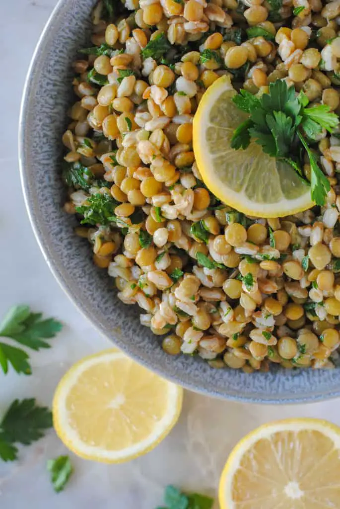 lentil and farro salad with lemon garnish