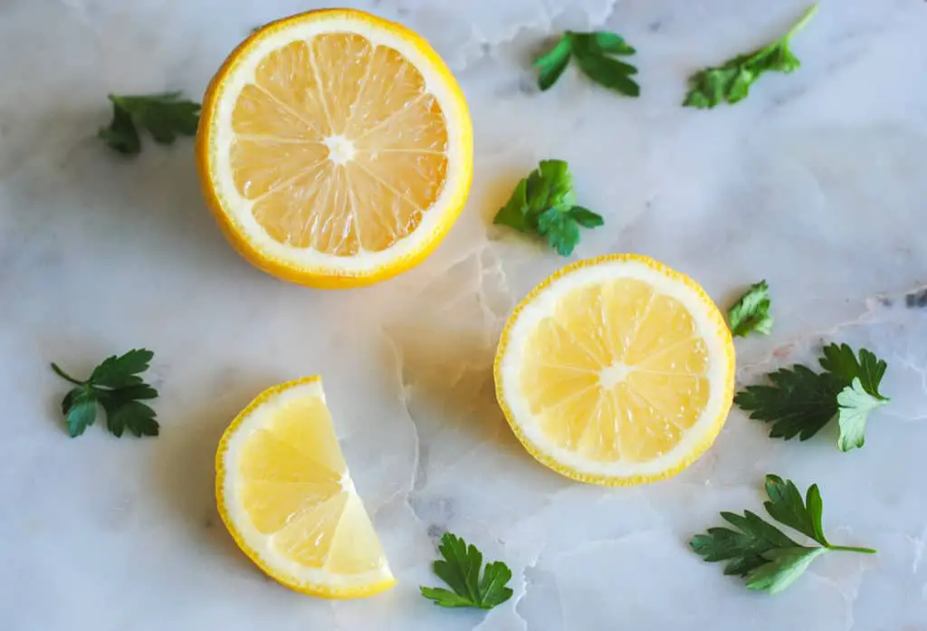 lemons and parsley on marble background