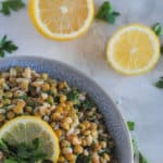 lentil and farro salad in blue bowl on marble cutting board