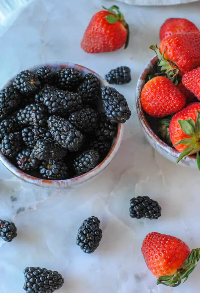 blackberries and strawberries in bowls