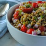 bowl of lentil salad made with tomatoes and dill