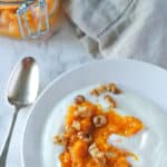 yogurt topped with peach preserves and walnuts