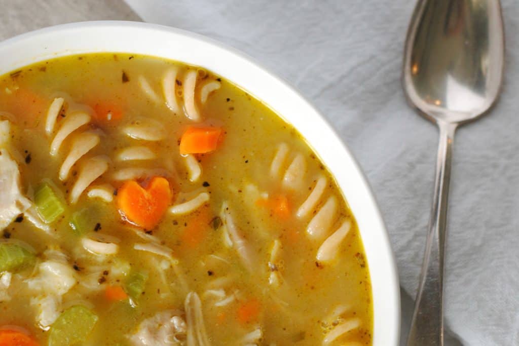 chicken soup in bowl on light background