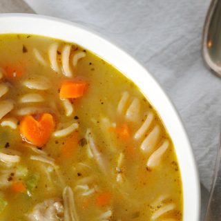 chicken soup in bowl on light background