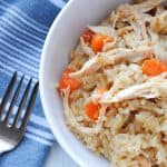 a fork alongside a bowl of chicken and rice