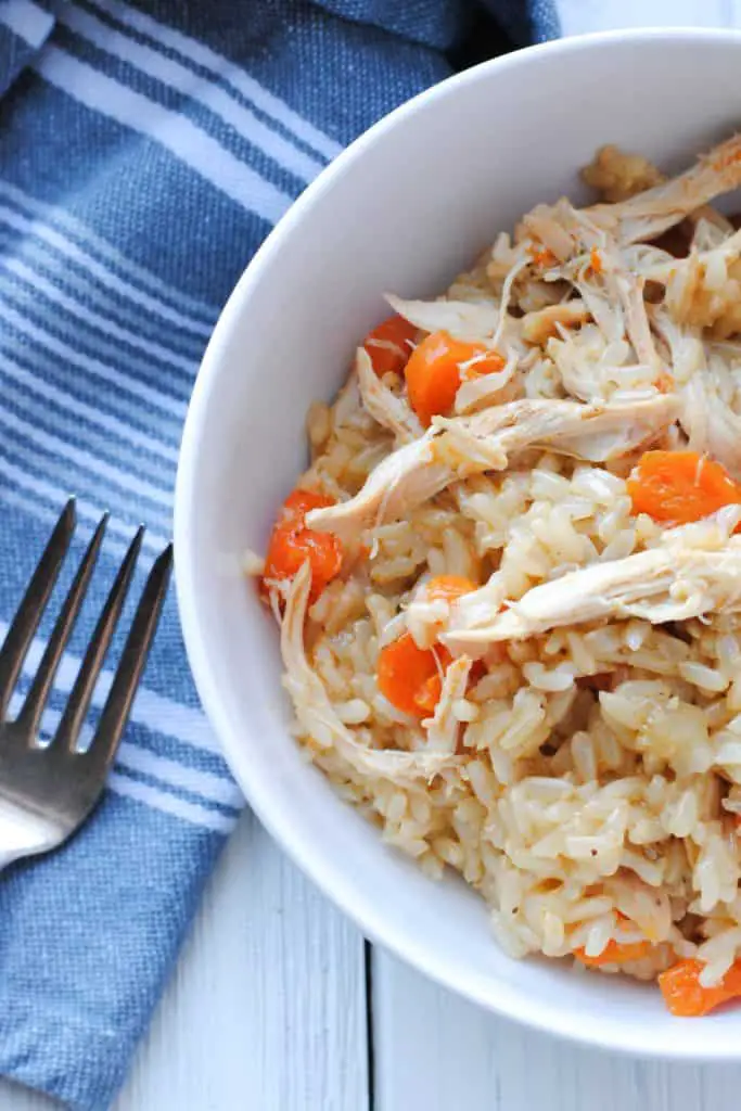 a fork alongside a bowl of chicken and rice