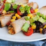 baked chicken taquitos with avocado, corn, black bean, and tomatoes